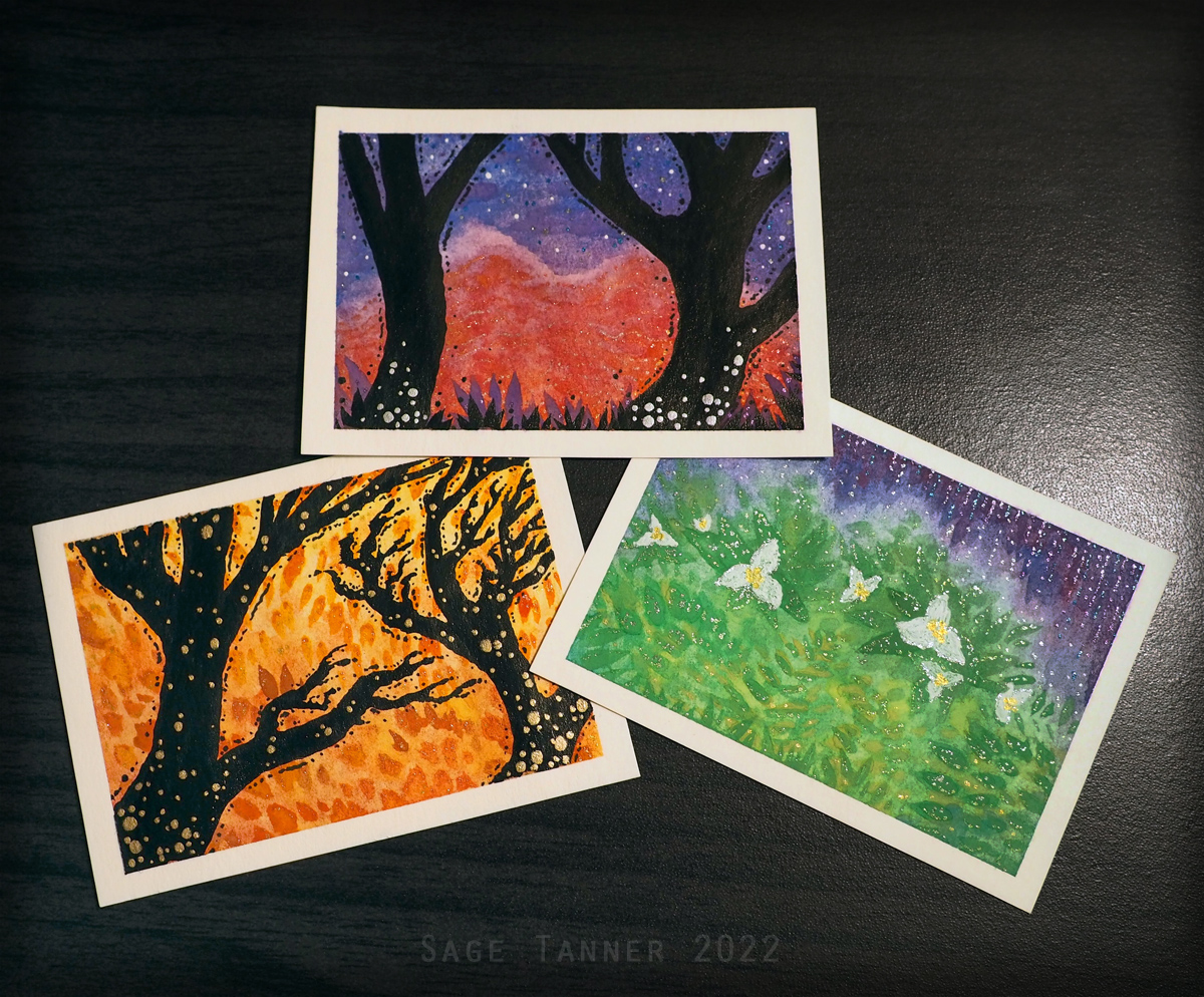 Three cards painted with various watercolor nature scenes.